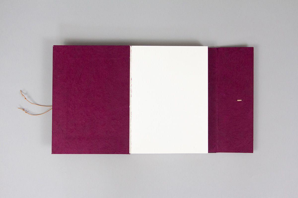 A magenta layflat journal with a wraparound closure